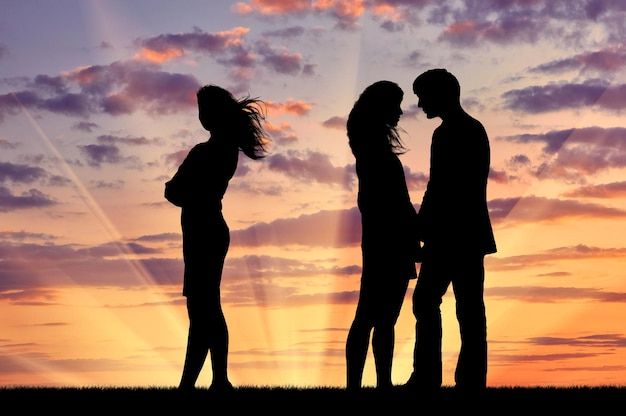 Premium Photo | Concept of betrayal and treason. Silhouette of a lonely woman near loving couple at sunset Premium Photo | Concept of betrayal and treason. Silhouette of a lonely woman near loving couple at sunset